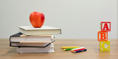 Books with an apple and pencils