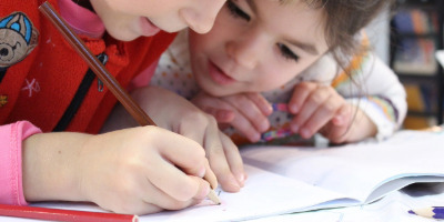 Kids writing in a book